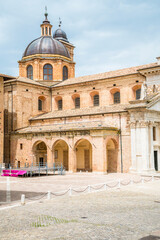Obraz premium A view down Puccini Street towards the Cathedral of Santa Maria Assunta in the center of the city in Urbino, Italy in summertime