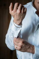 Elegant Touch: Man Adjusting Cufflinks with Grace and Style