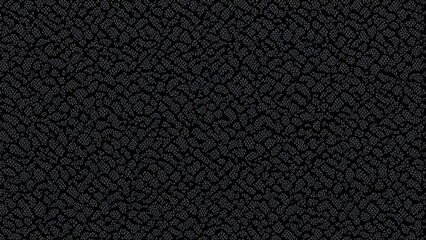 A textured black surface resembling small stones or gravel.