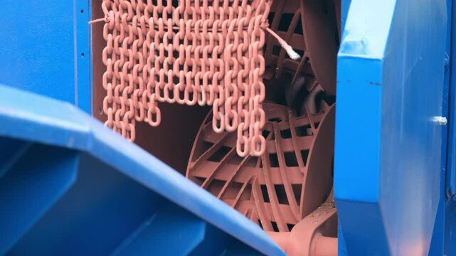 Rotating mechanism inside industrial wood debarking machine on woodworking plant. Part of conveyor line in timber manufacturing. Engineering technology in production. Modern equipment on factory.