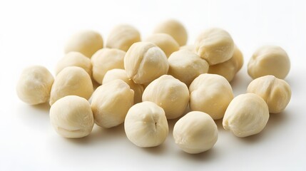 ealistic spread of blanched hazelnuts on a white background, showcasing their smooth, round shape and pale, off-white color with soft highlights