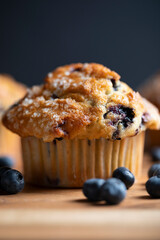 Cupcakes (muffins) with blueberries on a wooden board. A delicious summer dessert for morning tea or breakfast