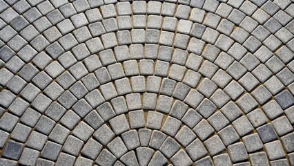 Gray cobblestone bricks floor with a half circle pattern background texture