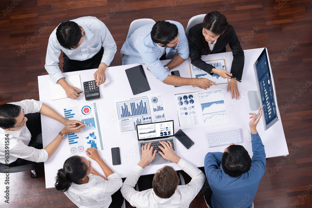 Leinwandbilder Top view analyst team utilizing BI Fintech to analyze financial data at table in meeting room. Analytic BI dashboard power on paper for business insight and strategic marketing planning. Prudent
