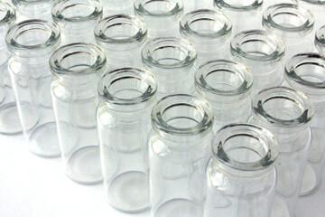 New glass vials for instrumental analysis on a white background. analytical vials prepared for chemical analysis