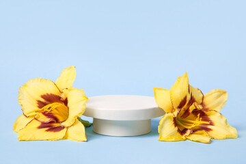 Concept scene stage showcase for new product, banner, promotion sale, cosmetic, presentation. White round podium and orange lily flowers on blue background.