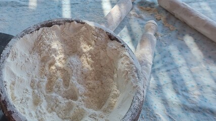 The process of using flour in baking dough to make bread