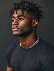 Obraz premium Model poses confidently in sleek black shirt against dark backdrop