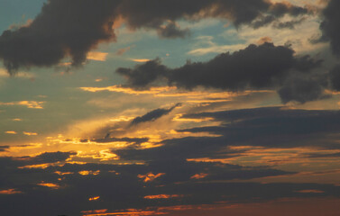 cumulonimbus clouds randomly covering the evening sky in the dusk