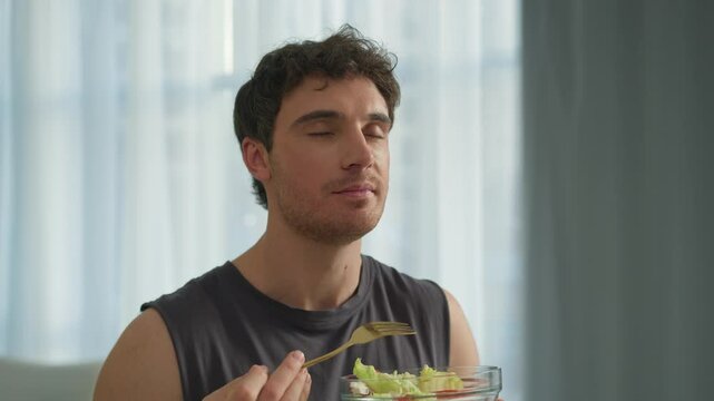 Caucasian man guy eating tasty salad healthy food vegetables lunch dieting vegetarian nourishment natural wellbeing sportsman strong motivation delicious fresh enjoyment male home breakfast vitamin