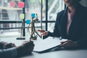 Legal Consultation: A lawyer meticulously reviews documents with a client in a professional office...