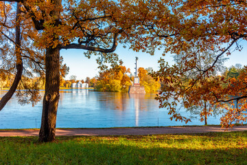 Grand pond with Grotto pavilion and Chesme column in autumn foliage in Catherine park, Pushkin...
