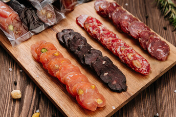 Sliced sausage with pistachios on wooden board, ideal for food presentations and gourmet displays