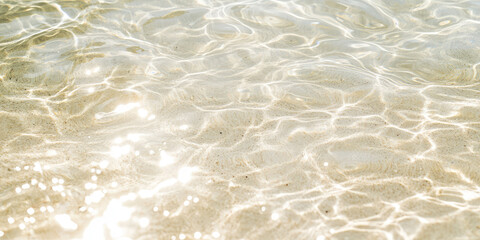 Clear Water Ripples Surface with white sand. Closeup of transparent sea water for presentation background, print, web, banner