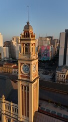 Naklejka premium Historic Clock Tower in São Paulo Cityscape at Sunset