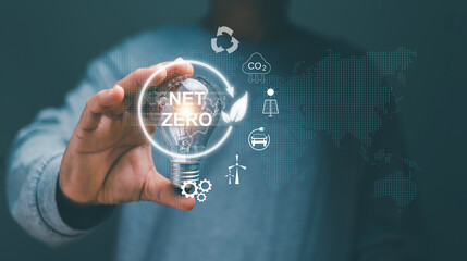 Net zero icon and carbon neutral concept. Man hand holding lightbulb for new idea to investment...