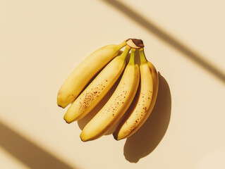 a bunch of bananas with a few spots on the peel indicating ripeness against an isolated background