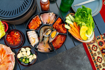 Korean food barbecue grill and alcohol drink vodka on the table. Asian people enjoy celebration...