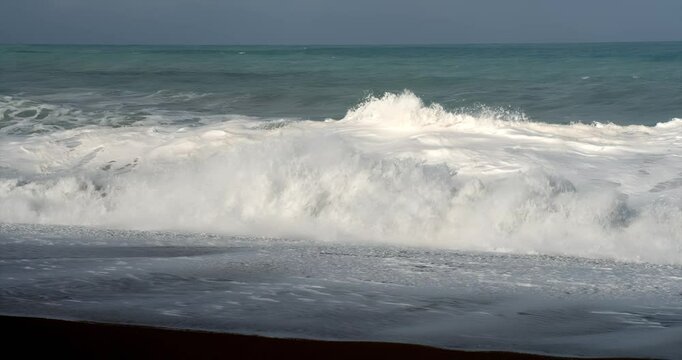 waves crashing at the beach in slow motion
