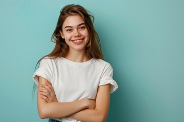 Fototapeta premium A young woman stands with her arms crossed, appearing confident and assertive