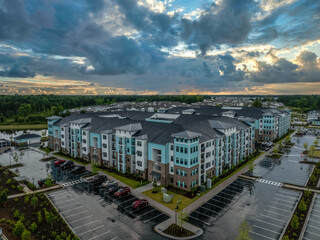 Aerial view of modern American apartment condo complex with turquoise vinyl siding dramatic...