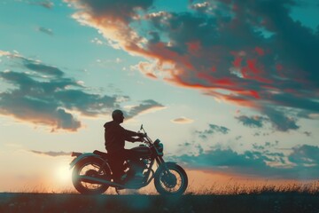A person riding a motorcycle on the side of a green hill, with no buildings or obstacles in sight