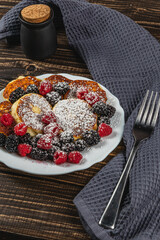 Cottage cheese pancakes with fresh raspberries, blackberries and powdered sugar