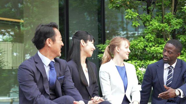 A group of multinational business people relaxing and talking