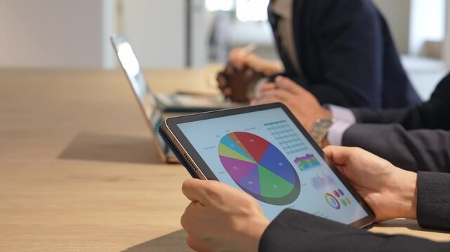 Business people having a meeting while looking at a tablet screen