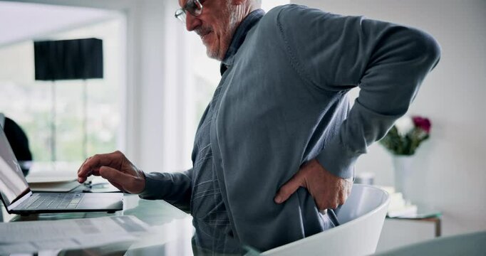 Back pain, office and mature man on laptop with injury for medical crisis, accident and inflammation. Stress, corporate manager and business person with muscle strain on computer for online proposal