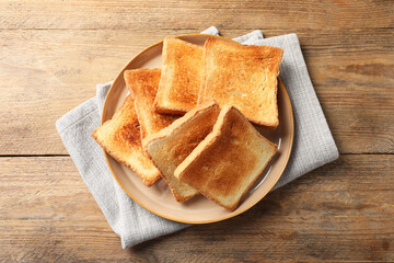 Delicious toasts on wooden table, top view