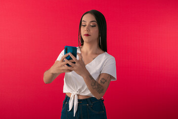 Young woman with smartphone simulating use with facial expressions.