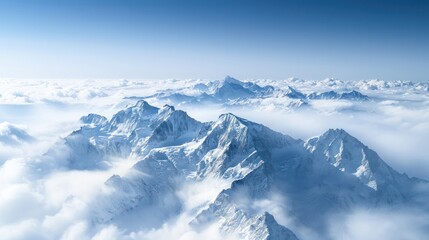 Fototapeta premium A panoramic photograph of a breathtaking mountain range shrouded in clouds, captured from an airplane window