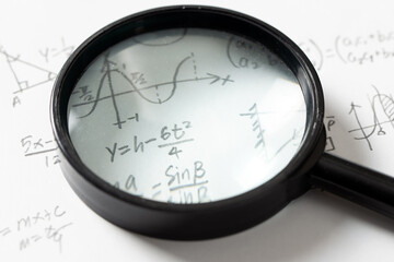 Mathematical Equations and Graph with Magnifying Glass