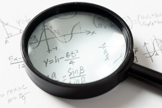 Mathematical Equations and Graph with Magnifying Glass
