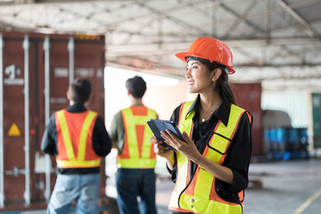 Asian warehouse woman worker working in warehouse. Asian woman worker inspecting quality of product in storage warehouse