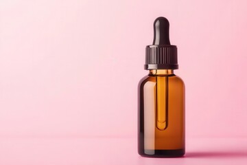 Amber glass dropper bottle on a pink background, suitable for essential oils, serums, or other beauty and skincare products.