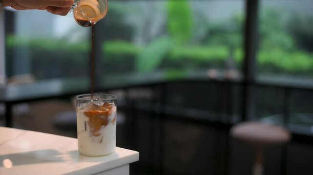 ice latte coffee in plastic glass on black table at cafe​