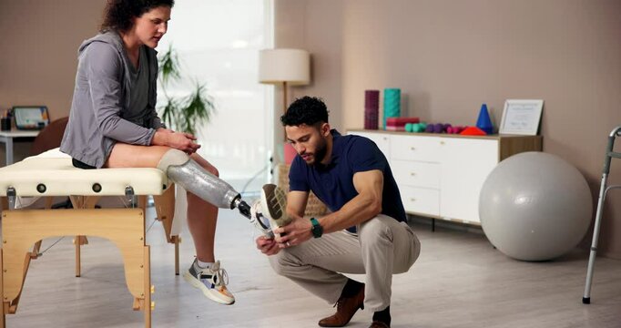 Physiotherapy, amputee and leg with people and rehabilitation for person with a disability, help and medical prosthetic. Healthcare, consulting and physical therapy with man and woman in clinic