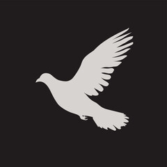 Silhouette of a dove in flight against a dark background, symbolizing peace and freedom.