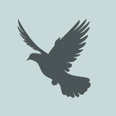 Fototapeta premium Silhouette of a bird in flight against a light blue background, capturing a sense of freedom and peace.