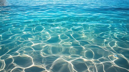 Fototapeta premium Crystal-clear blue water rippling gently on a sunny day, evoking the peaceful essence of summer.