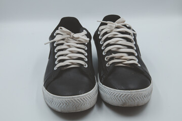 shoe sneaker on white background, close up of sneaker on white background, old black generic sneakers on white background.