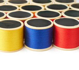spools of cotton embroidery sewing thread isolated white background, used in detail stitching or decorative fabric and textile industry