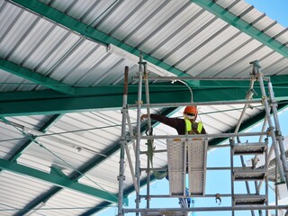 Working at height using personal protective equipment and safety harnesses Working on scaffolding
