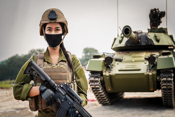 Fototapeta premium military US army soldier with mask full face hold machine gun near tank and ready to shot