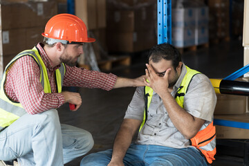 Male warehouse worker get accident at work in warehouse. Worker tired and thirst of water in...