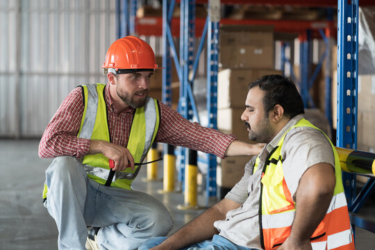 Male warehouse worker get accident at work in warehouse. Worker tired and thirst of water in warehouse. Health safe of work and safety first concept