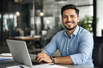 Smiling businessman working on laptop in office - Powered by Adobe