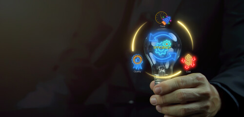 Business efficiency concept, how much a company or organization can produce as it relates to time, cost and quality. Businessman shows glowing neon line of efficiency icon inside lightbulb.